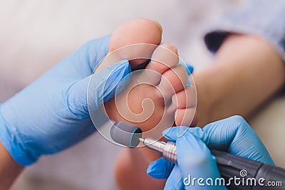 Process pedicure close-up, polishing feet, unrecognizable people. blurred face. Stock Photo