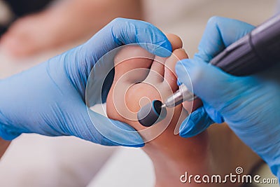 Process pedicure close-up, polishing feet, unrecognizable people. blurred face. Stock Photo