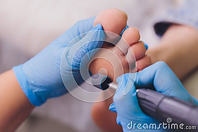Process pedicure close-up, polishing feet, unrecognizable people. blurred face. Stock Photo