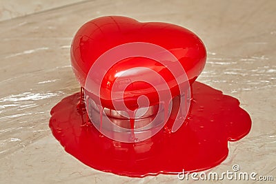 Process of pouring red glaze on heart shape form cake Stock Photo