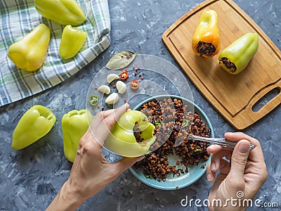 The process of preparing stuffed peppers with black rice and vegetables. Vegetarian organic food. Stock Photo