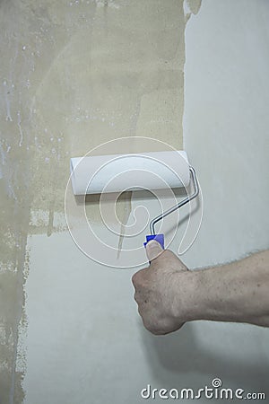 Process of priming plastered surface Stock Photo