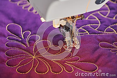 Process quilting with an electric sewing machine by using a free-motion technique Stock Photo