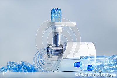 Process recycling plastic bottle in recycling machine. Stock Photo