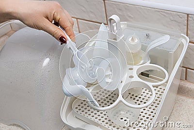 Using baby bottle sterilizer Stock Photo