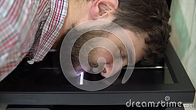 The process of scanning a man& x27;s face. Scanner in operation scans a human face with the lid open Stock Photo