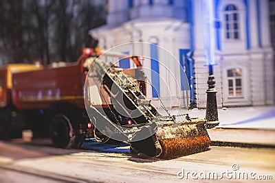 Process of snow removal on the city streets and roads with municipal vehicle, bulldozer, snowblower plow truck, snowplow, snow Stock Photo