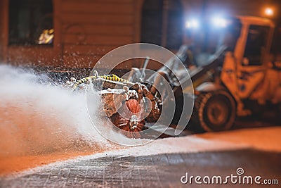 Process of snow removal on the city streets and roads with municipal vehicle, bulldozer, snowblower plow truck, snowplow, snow Stock Photo