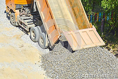 The process of unloading a dump truck, dump truck unloads rubble on the ground, top view. The concept of road construction, Stock Photo