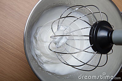 The process of whipping egg whites in a planetary mixer Stock Photo