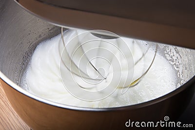 The process of whipping egg whites in a planetary mixer. Selective focus Stock Photo