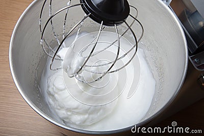 The process of whipping egg whites in a planetary mixer. Selective focus Stock Photo