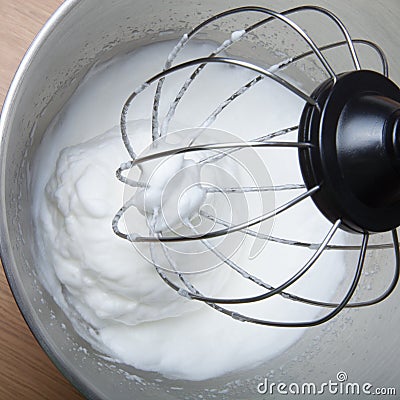 The process of whipping egg whites in a planetary mixer. Selective focus Stock Photo