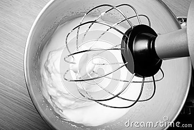 The process of whipping egg whites in a planetary mixer. Selective focus. Toned Stock Photo