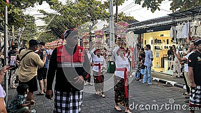 Procession of beautiful Balinese women in traditional costumes - sarong, carry offering on heads for Hindu ceremony. culture of Editorial Stock Photo