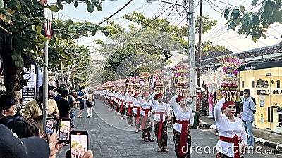 Procession of beautiful Balinese women in traditional costumes - sarong, carry offering on heads for Hindu ceremony. culture of Editorial Stock Photo