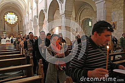 Procession from the church of St. Catherine to the cave in the Basilica of the Birth of Jesus, Bethlehem Editorial Stock Photo