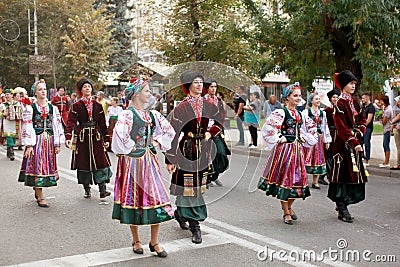 Procession of students of the Institute of culture, dancers in Cossack traditional dress, colored skirt, green trousers and maroon Editorial Stock Photo