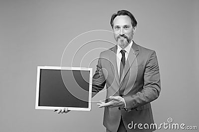 Product introduction. Businessman presenting product at blackboard. Product promotion. Product advertising. Promoting Stock Photo