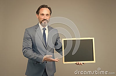 Product introduction. Businessman presenting product at blackboard. Product promotion. Product advertising. Promoting Stock Photo