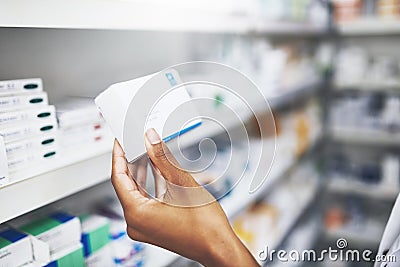 This is the product my customer was enquiring. an unrecognizable pharmacist picking medication from the shelves. Stock Photo