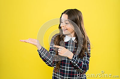 Product presentation. Small girl nice hairstyle. Child long curly hair. Happy schoolgirl stylish uniform. Happy Stock Photo