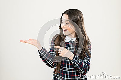 Product presentation. Small girl nice hairstyle. Child long curly hair. Happy schoolgirl stylish uniform. Happy Stock Photo