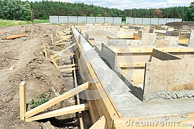 Production of the concrete base under the house with use of a removable timbering. Stock Photo