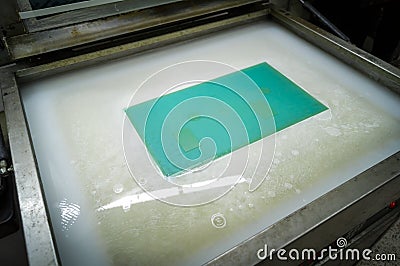 Production of flexographic printing plates. Washing of polymer molds for the printing machine. Soft focus Stock Photo