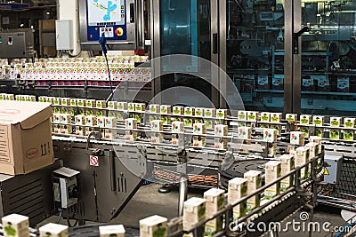 production of juices in cardboard packaging. Industry, Metal Works. Editorial Stock Photo
