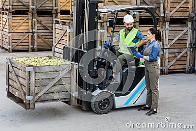 Production of juices and purees, work in warehouse, modern devices for managing loading Stock Photo