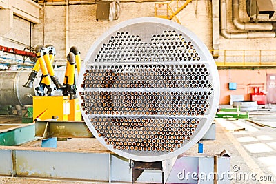 Production of a large tube bundle for a shell-and-tube heat exchanger in an industrial production room of a shop with equipment Stock Photo