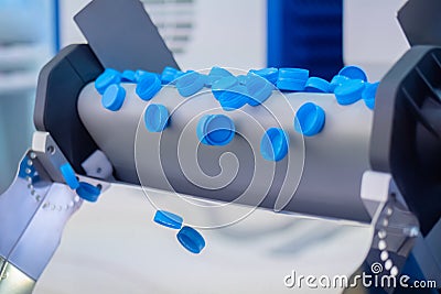 Production line - many blue plastic bottle caps falling from conveyor belt Stock Photo
