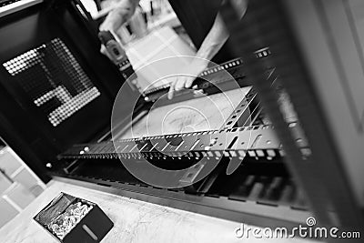 Production line worker seen assembling data cabinets at a factory. Stock Photo