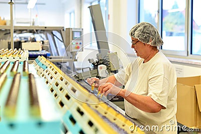 Production of pralines in a factory for the food industry - women working on the assembly line Stock Photo