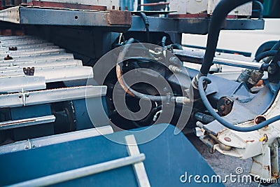 Production of tractors, parts of the tractor and also instruments onveyor assembly stage the body of tractor at factory. Stock Photo