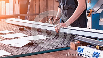 Production windows pvc, a man writes on the plastic profile dimensions, close-up, pvc, write a marker, arm Stock Photo