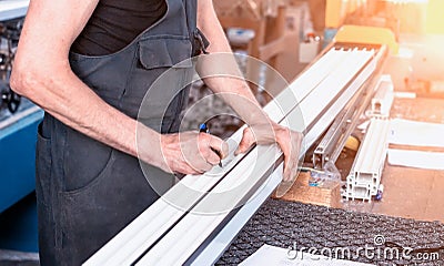 Production windows pvc, a man writes on the plastic profile dimensions, close-up, pvc, write a marker, arm Stock Photo