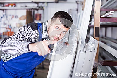 Production worker with PVC windows Stock Photo