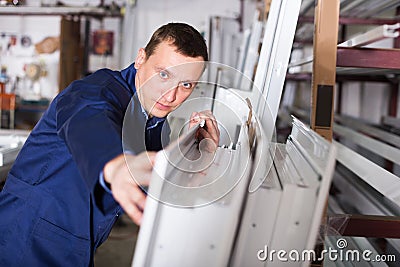 Production worker with PVC windows Stock Photo