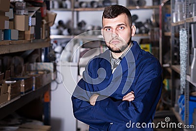 Production worker in uniform displaying his workplace Stock Photo