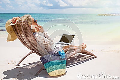 Productive businesswoman working on the beach Stock Photo