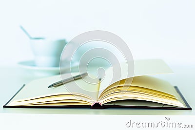 Office notebook and pen with coffee cup. Stock Photo