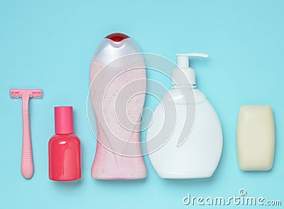 Products for the care of body, hair and personal hygiene on a blue pastel background. A bottle of fragrant perfume, lotion, shampo Stock Photo