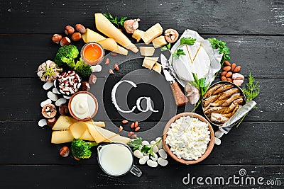 Products containing natural calcium: cheese, milk, parmesan, sour cream, fish, almonds, parsley, garlic, broccoli. Stock Photo