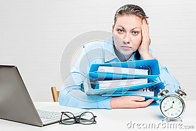 Professional accountant with a bunch of documents working overtime at night Stock Photo