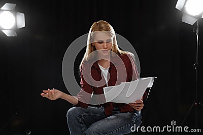 Professional actress reading her script during rehearsal in theatre Stock Photo