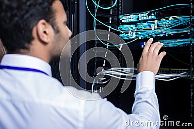 Professional IT administrator checking internet cables Stock Photo