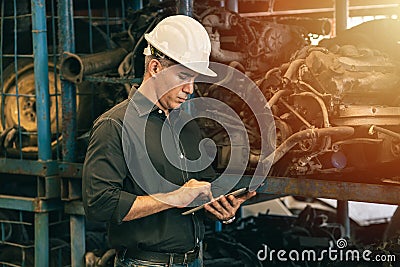 Professional adult Engineer male attending duty work in factory working checking stock inventory data with tablet computer Stock Photo