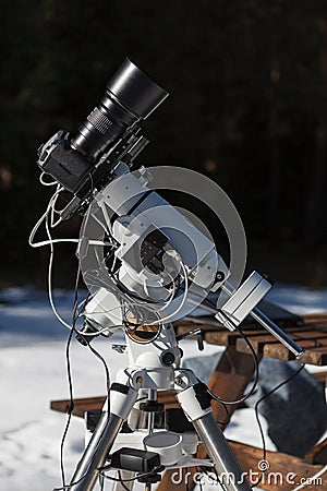 Professional astrophotography setup equipped with DSLR camera, telephoto lens and guider scope Stock Photo